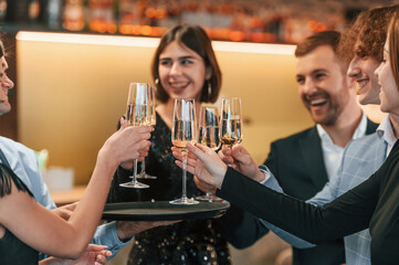 Sitting together. Group of people in elegant clothes are in the restaurant celebrating event