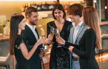 Conception of celebrating event. Group of people in elegant clothes are in the restaurant