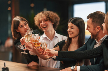 Sitting together. Group of people in elegant clothes are in the restaurant celebrating event
