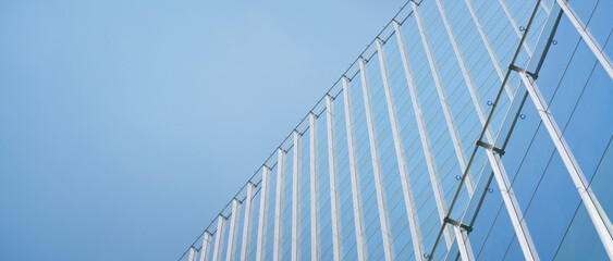 close-up soft light pattern glass wall facade exterior architecture building reflection blue sky...
