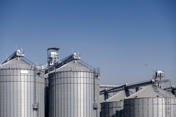 Grain Storage Silos under blue sky.