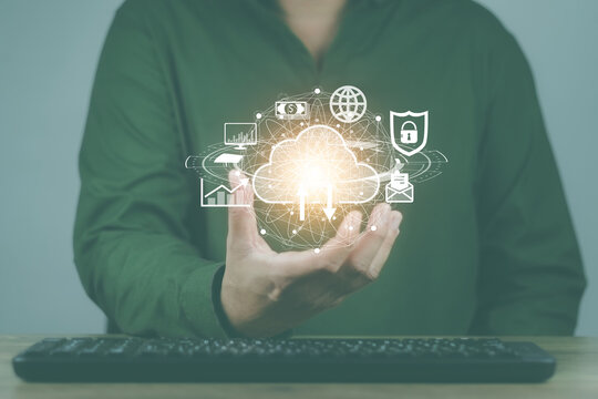cloud computing concept man's hand holding a virtual image cloud storage which is a form of digital computer data storage That helps facilitate both small and large organizations as well
