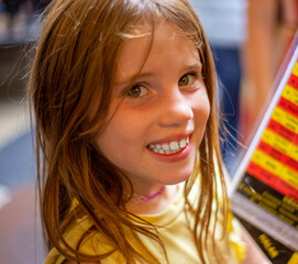 Beautiful blonde girl looks at camera smiling