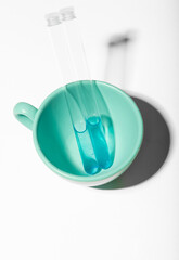 test tube inside ceramic cup 
