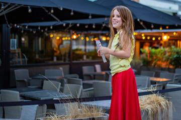 Beautiful blonde girl smiles, unfocused lights at background