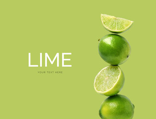 Creative layout made of lime on the green background. Flat lay. Food concept.
