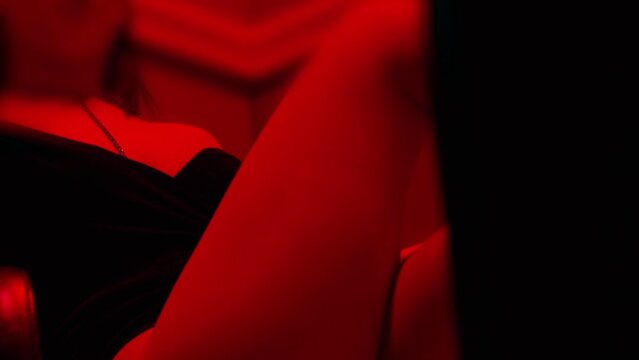 Beautiful sexy woman in short dress or swimwear dancing middle of doorway . Sensual scene of female model doing different sexy movements . Erotic performance in private room of strip poledance club