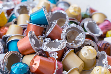 Pile opened gutted empty coffee capsules. Separate waste collection, recycling aluminum capsules. Container prepared recycling environmental protection reasonable consumption personal responsibility