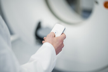 Close up picture of males hand holding a remote control arrangement