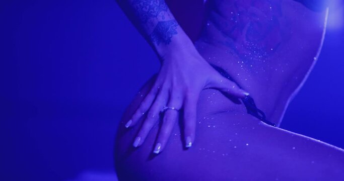 Sexy woman in bikini shaking her bottom. Female artist clapping her butt . Glitter on body skin . Shot on RED Cinema Camera in super slow motion 200ps .Erotic performance in private room of strip club