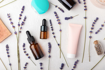 SPA. Lavender flowers, scented candle, body cream, essential oil, scrub and handmade soap. Natural herbal cosmetics with lavender flowers on a white texture background.FLET LAY © Avocado_studio