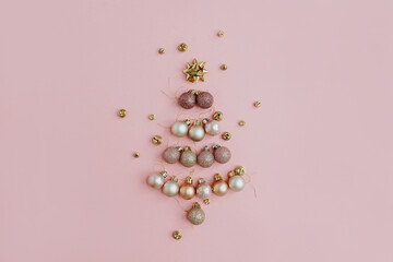 Christmas composition. Christmas tree made of colourful ball decoration on pink background. Flat lay, top view, copy space. New Year holiday card