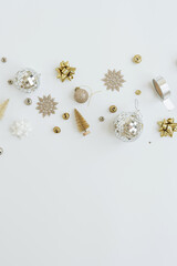 Elegant Christmas composition. Gold Christmas tree decorations: baubles, balls, stars, ribbons. Flat lay, top view holiday concept