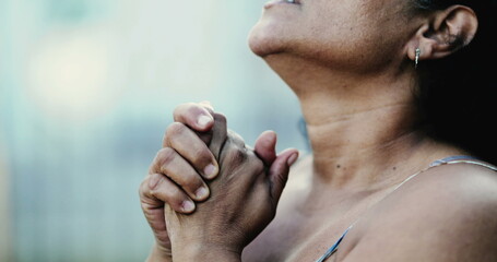 Hispanic black woman praying to God, close-up hand