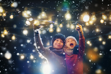 Cute girl and boy enjoying the holidays at Christmas. Decorate family feast.