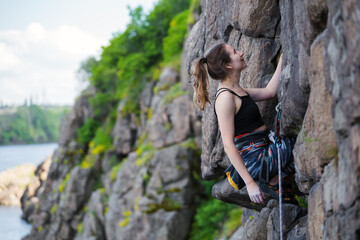 A girl climbs a rock