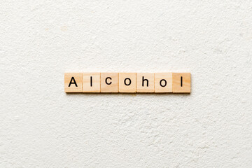 alcohol word written on wood block. alcohol text on table, concept