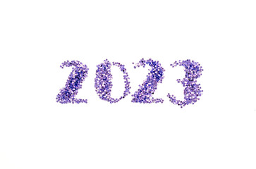 Year 2023 written in purple glitter stars on white background