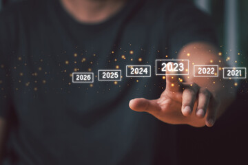 A man touching on virtual screen 2023. Business new year concept, welcome to year 2023 concept.