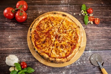 Pizza Margherita with ingredents top view on wooden table