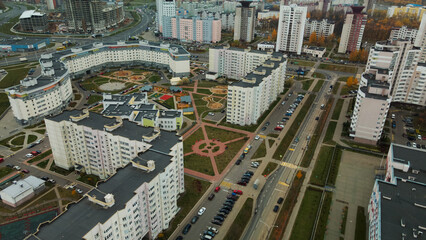 Fototapeta premium Multi-storey buildings with infrastructure. Densely populated urban area. Overcast weather. Autumn landscape. Aerial photography.