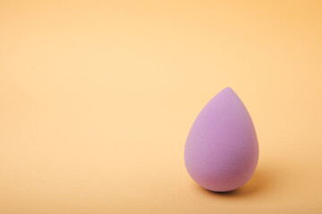 Bright beauty lips on a brown background. Beauty blender cosmetic tool for applying and blending products like foundation, concealer.Beauty concept. Copy space for text.