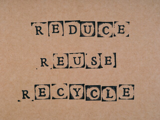 A cardboard with words Reduce, Reuse, Recycle