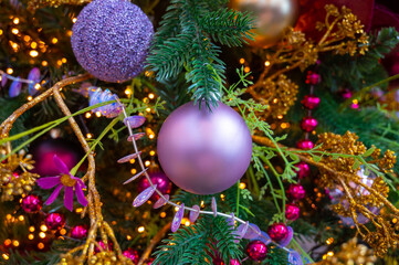 Christmas tree decorated is festivily decorated with vintage colorful balls, garlands and toys close up, Christmas background