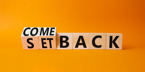 Comeback and setback symbol. Turned cubes with words setback and comeback. Beautiful orange...