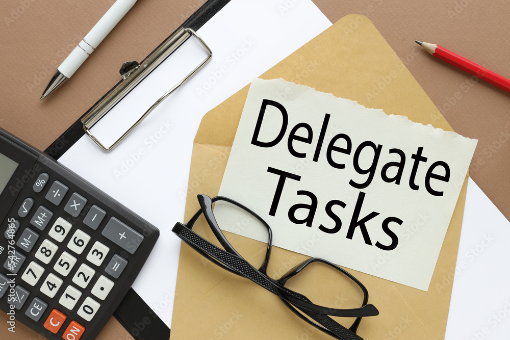 Poster delegate tasks written on notepad page on envelope