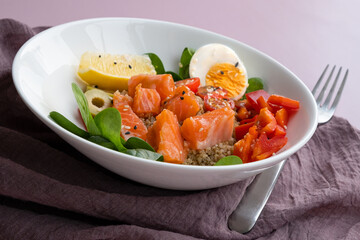 bowl plate with poke dish. fresh salmon, quinoa, spinach, lemon for a healthy diet. copy space.