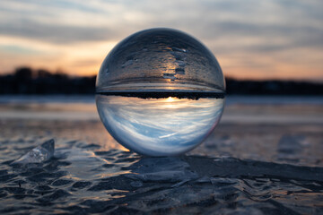 A View through this lens ball shows the sunset from the ics on the Susquehanna River near...