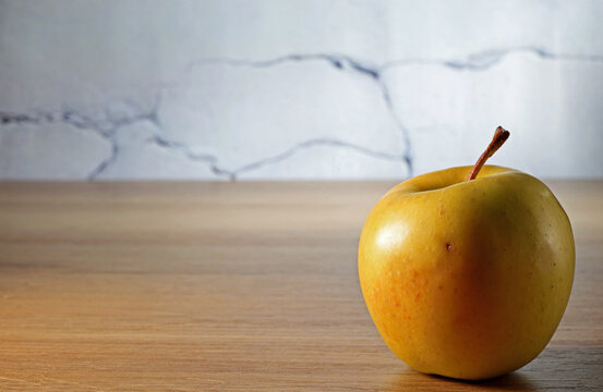 yellow apple on a wooden background
