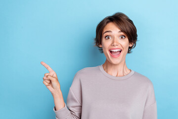 Photo of nice speechless woman short hairdo dressed gray sweatshirt indicating empty space open...