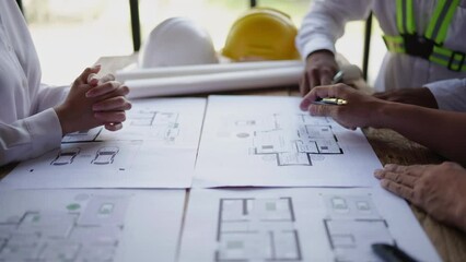Closeup of hands engineer and architect team have a meeting and discussed about construction and architectural drawings works.