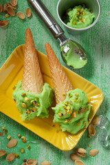 homemade pistachio ice cream on green wooden table - closeup