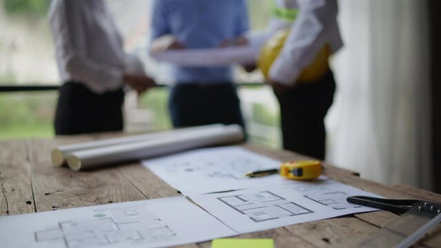 Closeup of hands engineer and architect team have a meeting and discussed about construction and architectural drawings works.