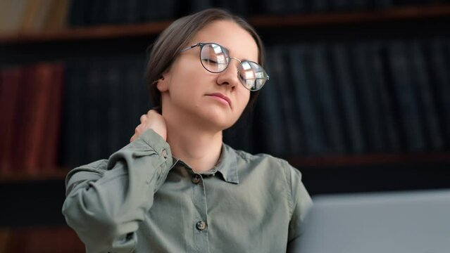 Tired business academic woman working laptop neck head pain suffering weakness powerless workaholism