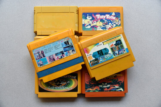 Chelyabinsk/Russia – 11 01 2022: Old plastic game cartridges with images of famous computer games from consoles.
