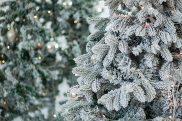 Background of artificial fir trees covered with artificial snow