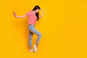 Fototapeta na wymiar Full length profile photo of charming cheerful girl have fun good mood dance isolated on yellow color background