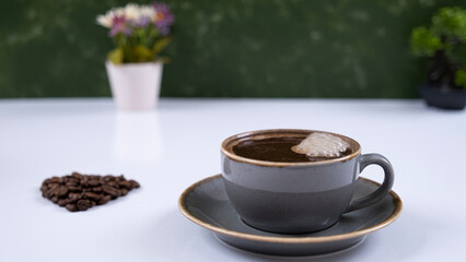 Image of coffee mug and coffee beans on a white background