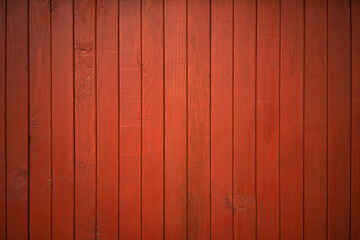 Red wooden background made of boards. Siding on the wall of the house. The texture of the wooden...