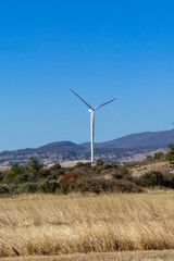 A beautiful landscape with wind turbines against a cloudless sky.