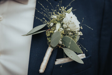 Small bouquet stuck on a wedding suit