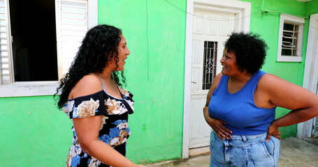 Naklejka premium Hispanic women gossiping in emotional conversation. Latinas talk