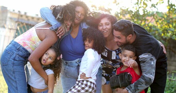 Hispanic family photo outside, real people embrace together