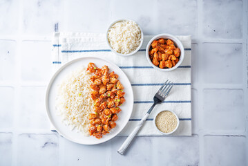 Sweet and sour chili sauce chicken with rice in a plate