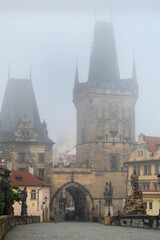 Fototapeta premium Cityscape - view of the Malа Strana Bridge Tower from the Charles Bridge in the early morning, Prague, Czech Republic