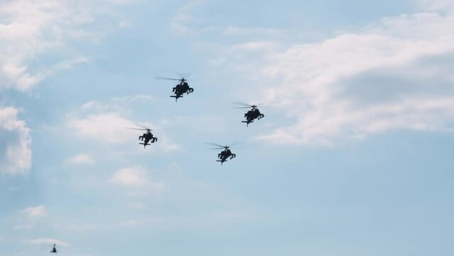 Thessaloniki, Greece - October 28 2022: Boeing AH-64 attack helicopters on formation during an air show. Greek Air Force Apache flying during the 28 October National Oxi Day parade.